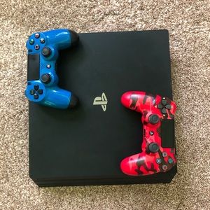 PlayStation 4 with two wired PlayStation controllers.